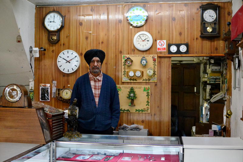 A watch and clock maker in his shop