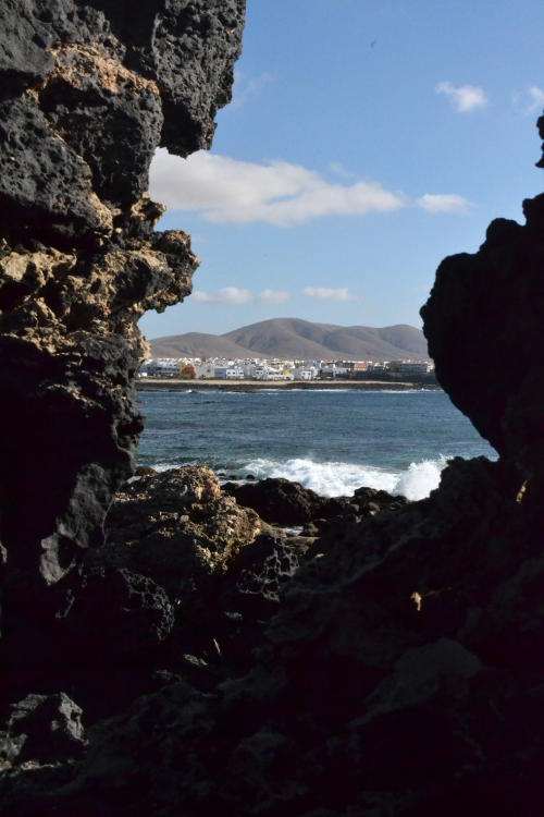 View of the sea between rocks at El Cotillo