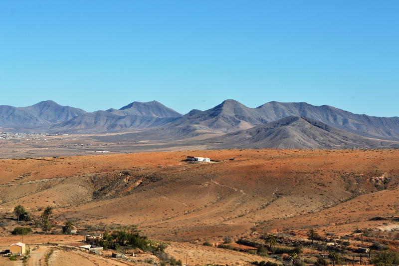 View towards mountains across a barren valley