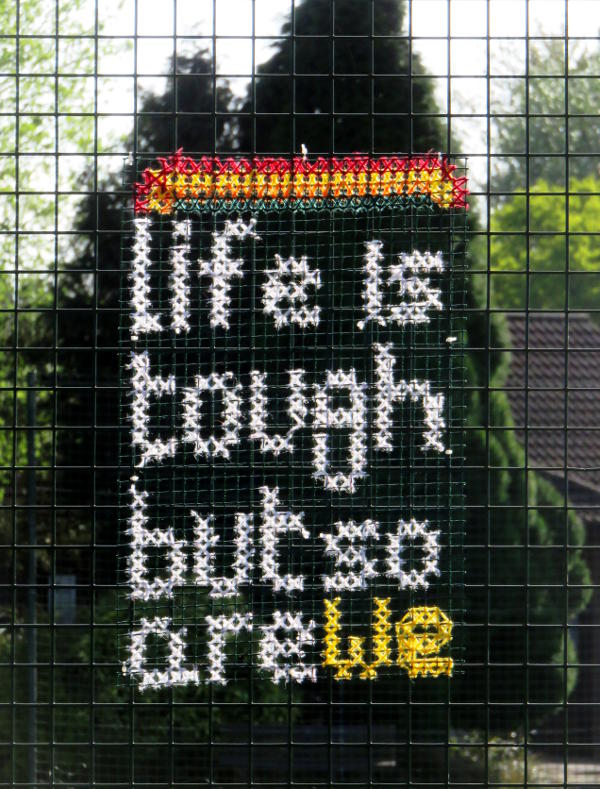 An embroidered message: Life is tough but so are we