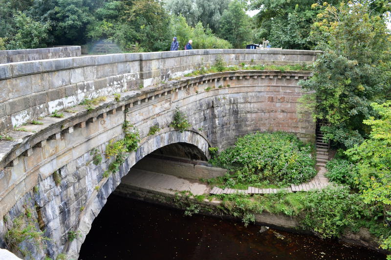 A stone aqueduct over a river