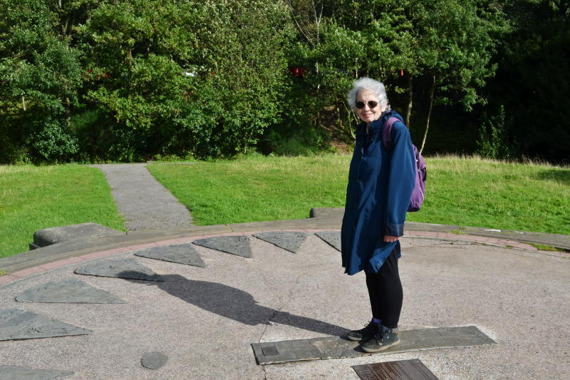 Miriam standing in the centre of a giant sundial