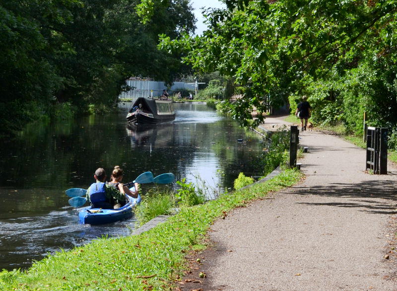 A rowing boat and a narrowboat on the canal