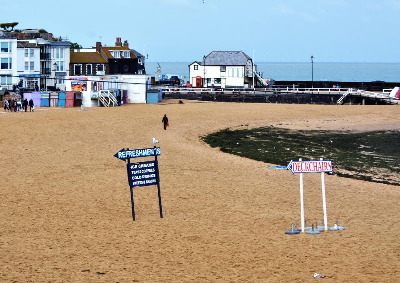 A beach with direction signs