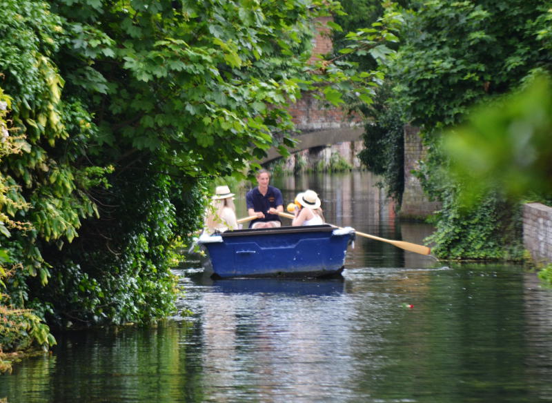 People in a small boat on the River Stour at Canterbury