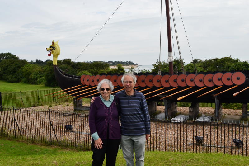 Miriam and Phil standing in front of a Viking longship