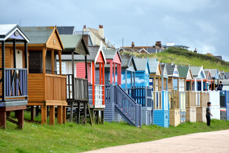 Brightly-coloured beach huts on a hillside