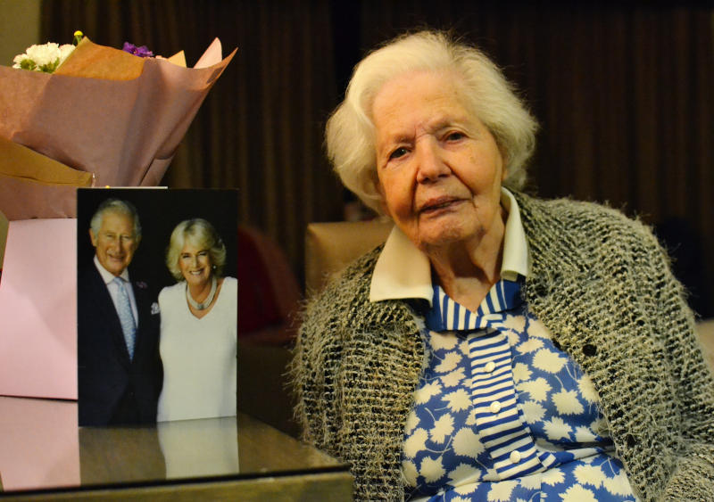 Hanna with a 100th birthday card from the King and Queen Consort