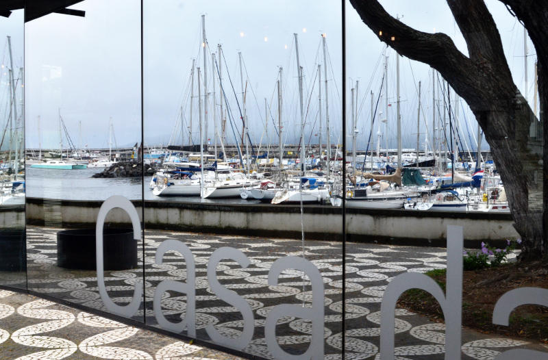 Reflection in a window of yachts in a harbour