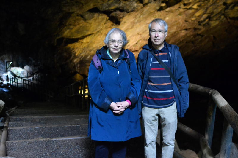 Miriam and Phil in a cave, with illuminated ceiling behind