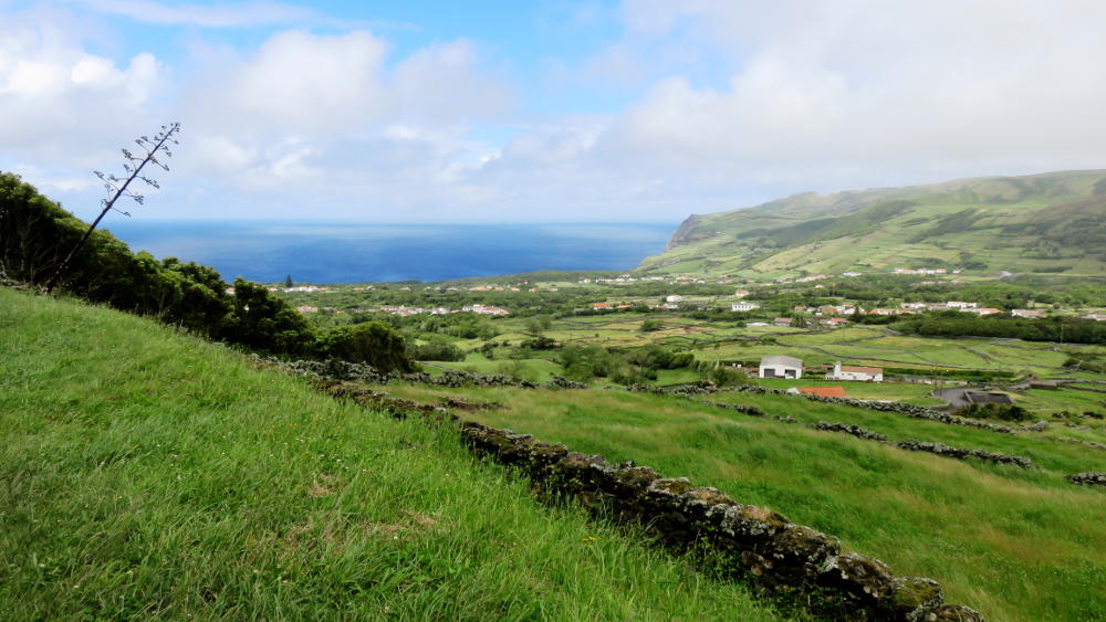 View across fields to a village and the sea