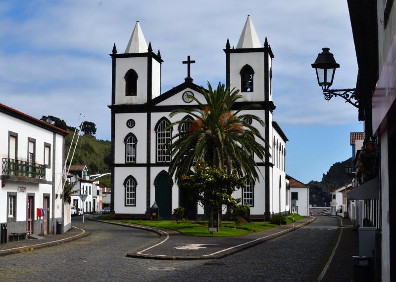 An Azorean church with a palm tree in front