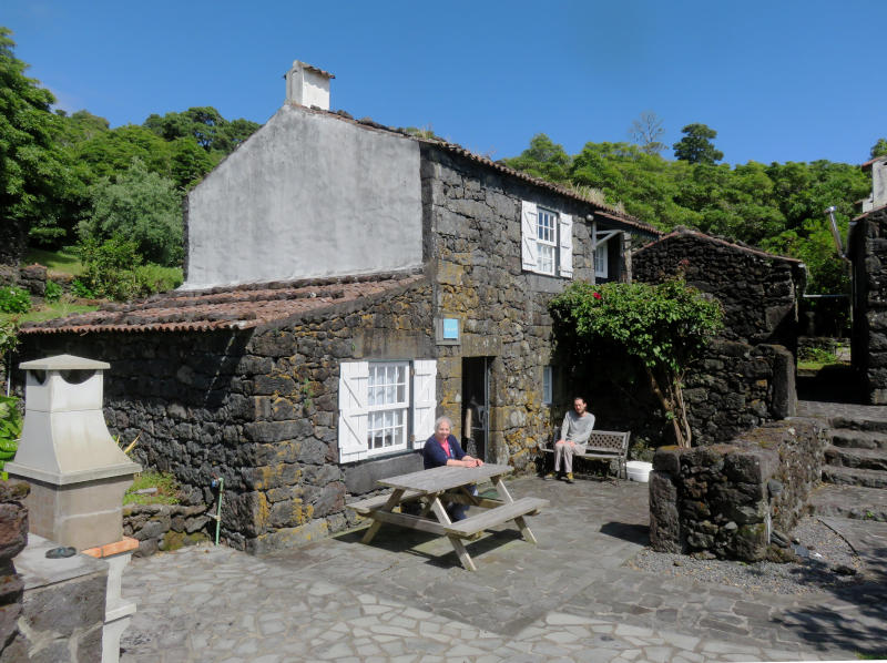 Miriam and Martin outside a stone cottage