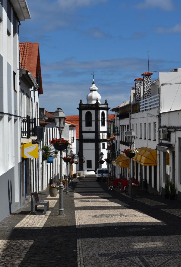 View along a shopping street to an old church