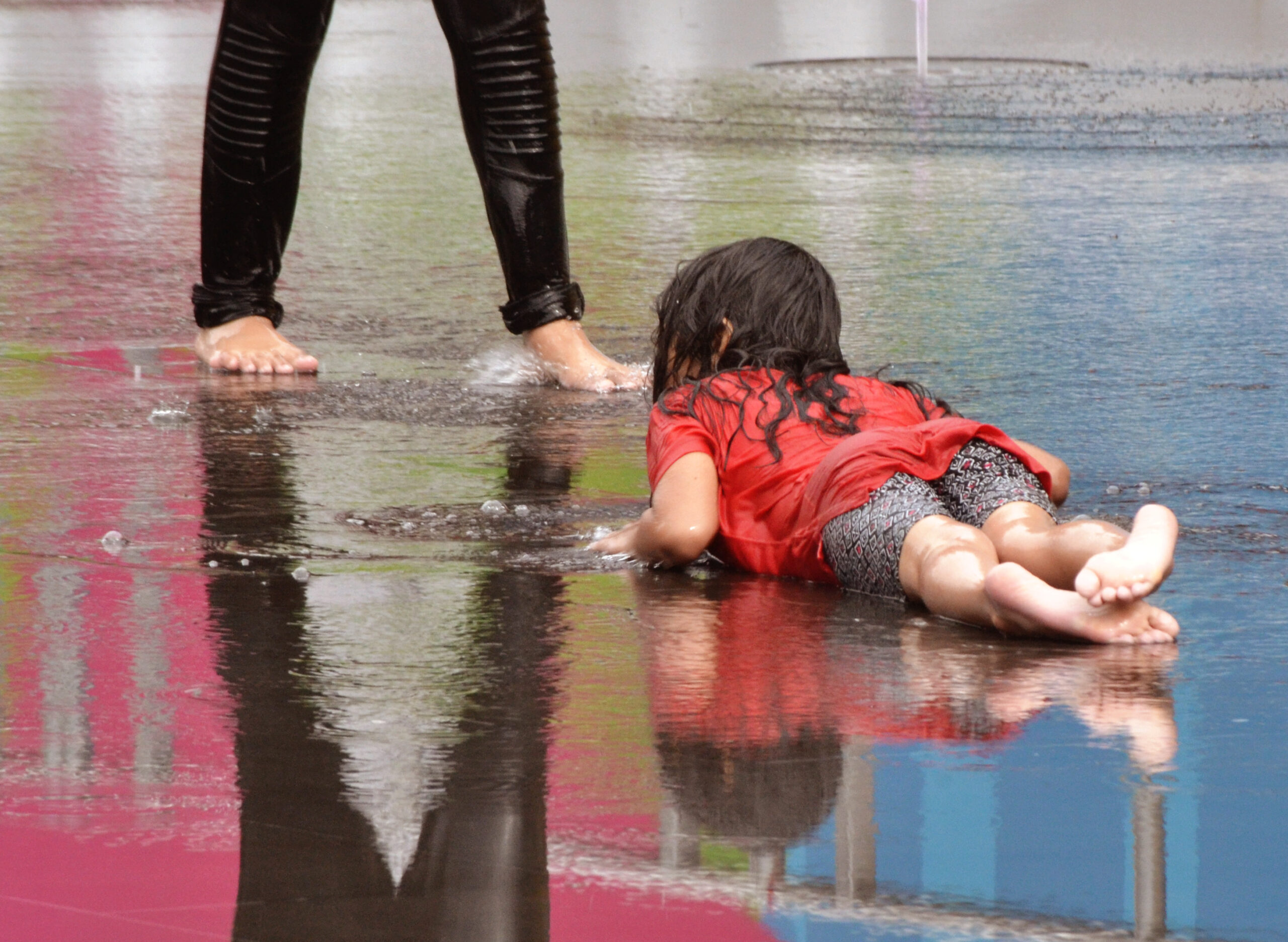 Lying face down in a very shallow pool of water