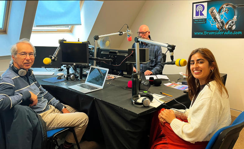 Phil, presenter Shaun Molloy behind microphones, and film-maker Gugan Gill in a radio studio