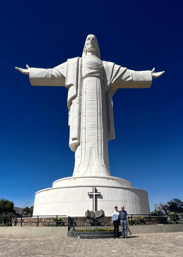 A huge statue of Christ, with outstretched arms, and Alison and Phil looking very small standing at the base