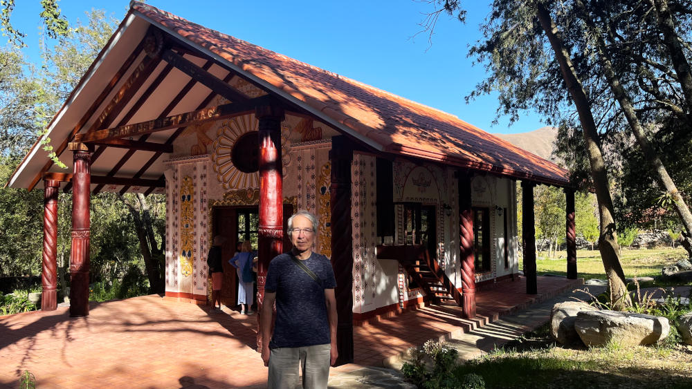 Phil standing in front of an ornate chapel in grassland