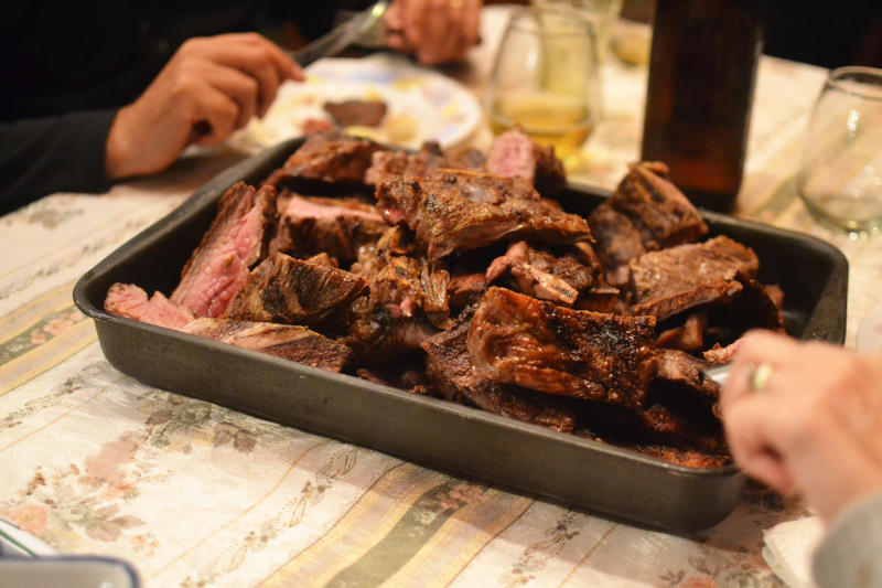 Large chunks of cooked beef in a metal tray