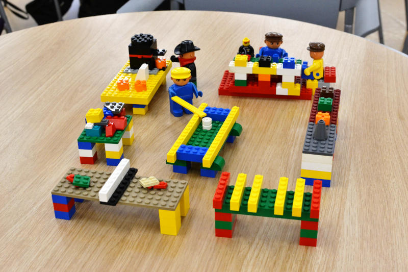 Lego models of a pool table, table tennis, people eating at a table and more