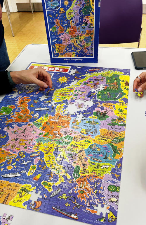 A jigsaw puzzle nearly completed, showing a map of Europe
