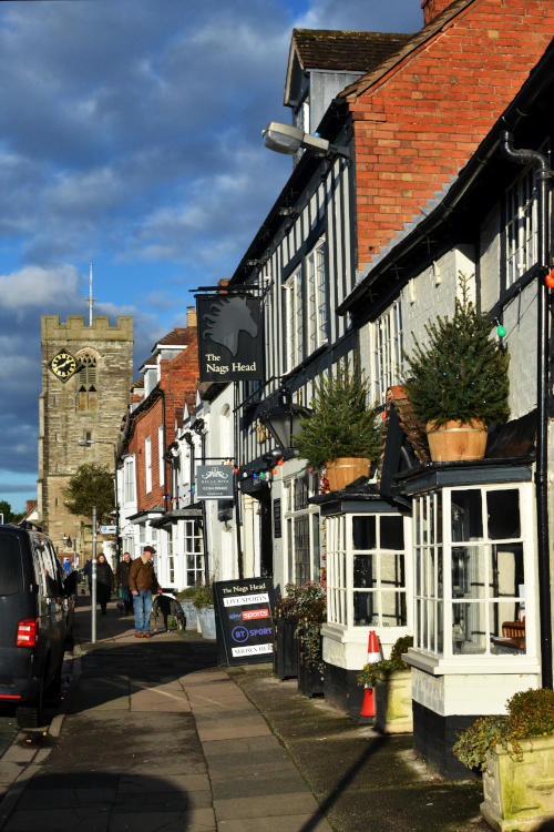 A Georgian shop front, a pub sign and, in the background, a church tower