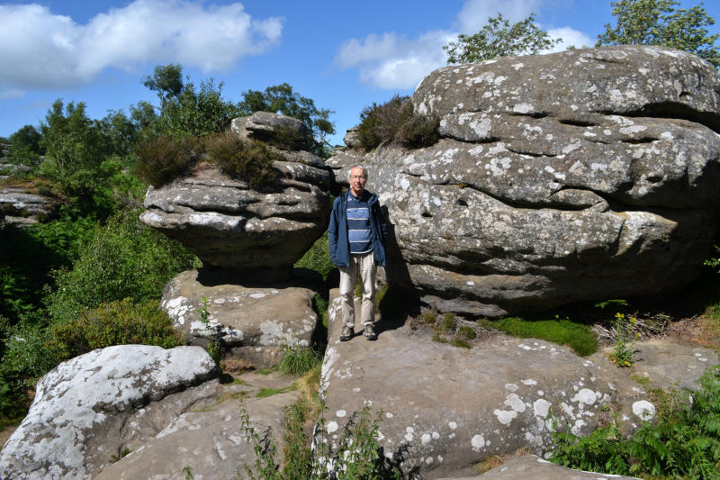 Phil standing in front of some large irregular rocks