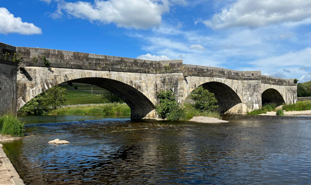 Bridge with several arched spans over a wide river