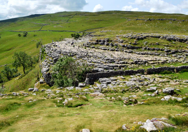 Looking down over a limestone pavement rock formation surrounded by moorland