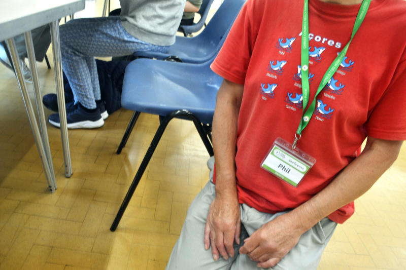 Closeup of Phil's chest wearing a red Azores T-shirt, but with his head not in frame