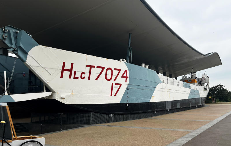 Outside view of a D-Day landing craft, on land, under a roof