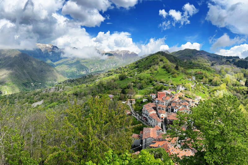 Looking down over rooftops of the village, with mountains behind