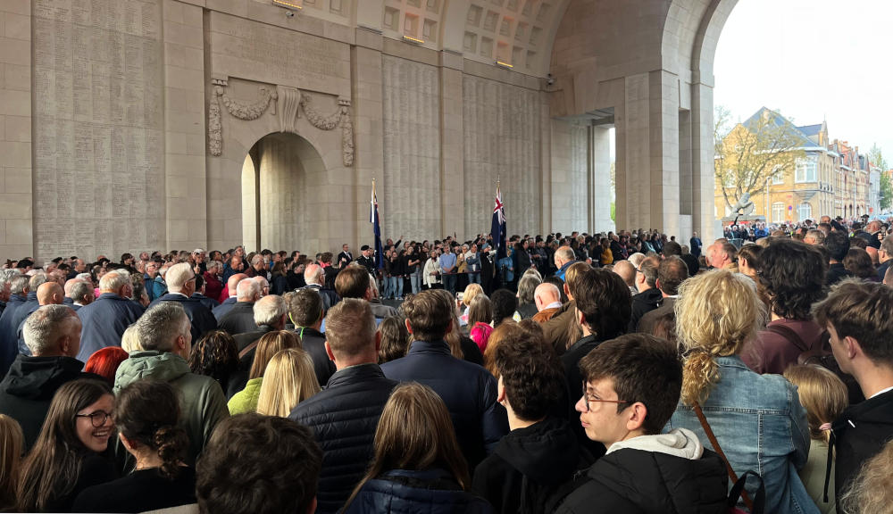 Crowds gathered under the Menin Gate at the nightly ceremony: in the distance are the flags of Australia and New Zealand