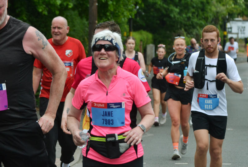 Runner Jane with a pink top among a group of runners on Pershore Road