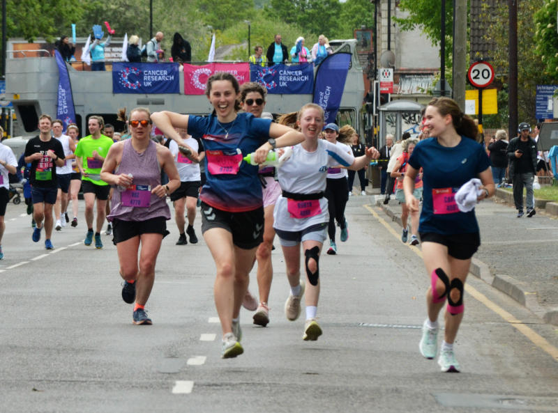 Runner Ruth with a dark blue top among a group of runners on Pershore Road