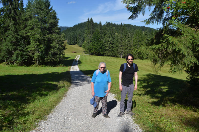 Miriam and Martin standing on a wide path in open grassland, with trees in the middle distance