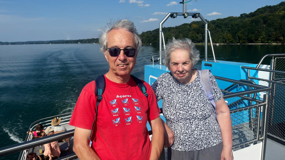 Phil, wearing sunglasses, and Miriam with part of a large lake in the background
